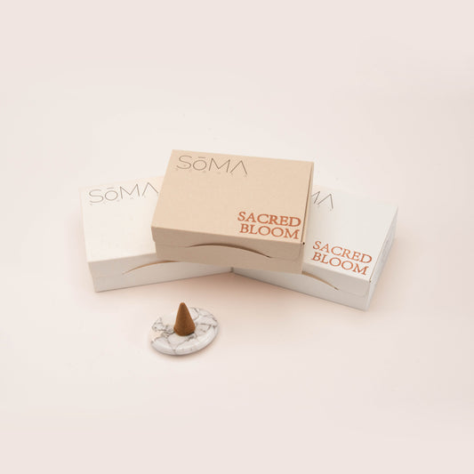SomaScents incense cone set with minimalist white and beige packaging, displayed alongside a single cone on a marble-style gemstone holder.