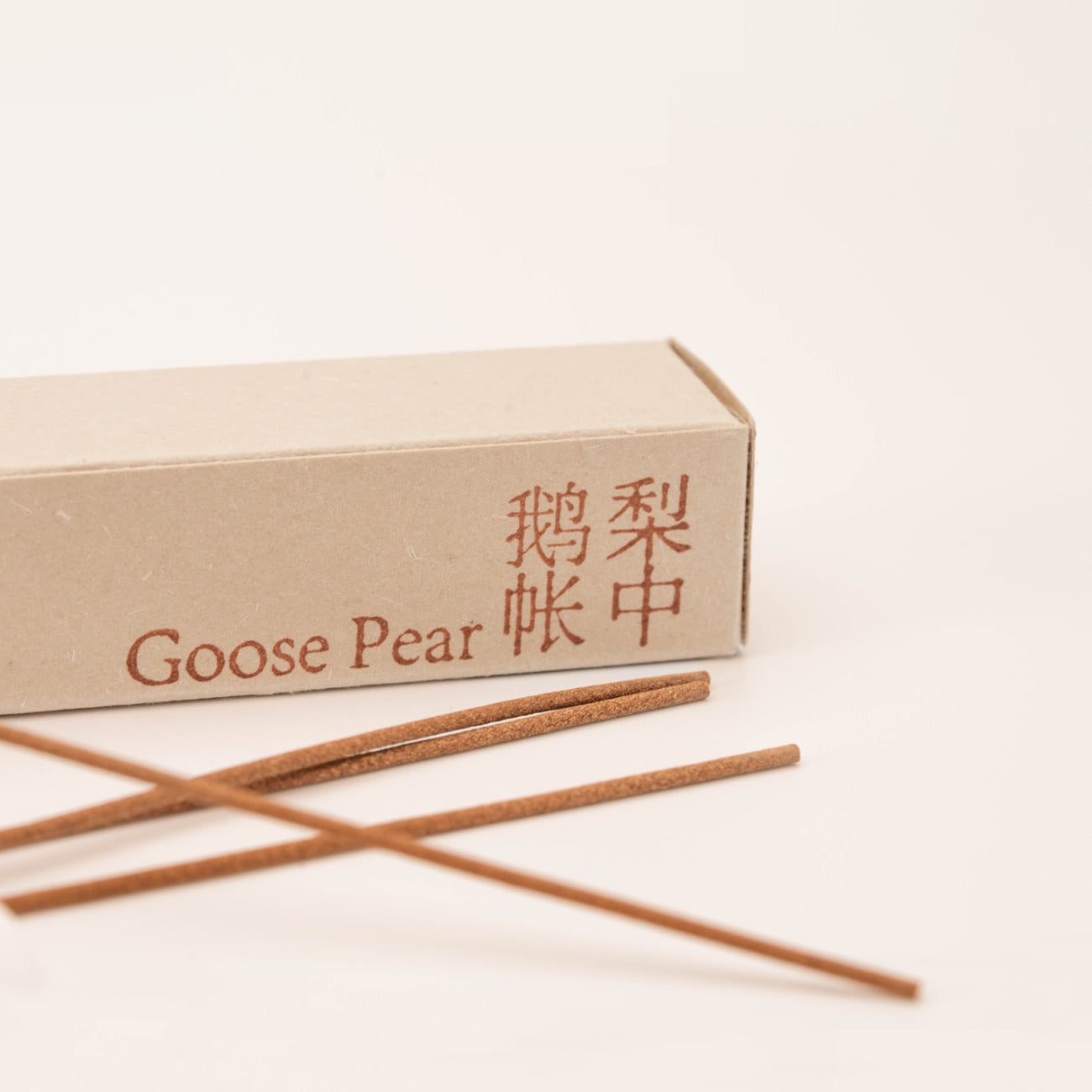 Close-up of SomaScents Goose Pear incense sticks, displayed on minimalist packaging with a soft, neutral background.