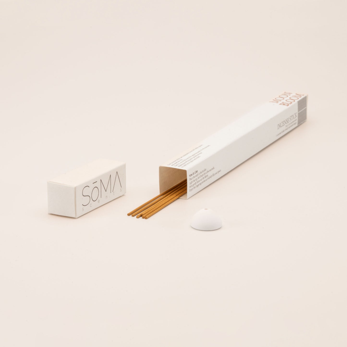 SomaScents Moon Bloom incense sticks in minimalist packaging, displayed with yellow incense sticks and a small white ceramic holder
