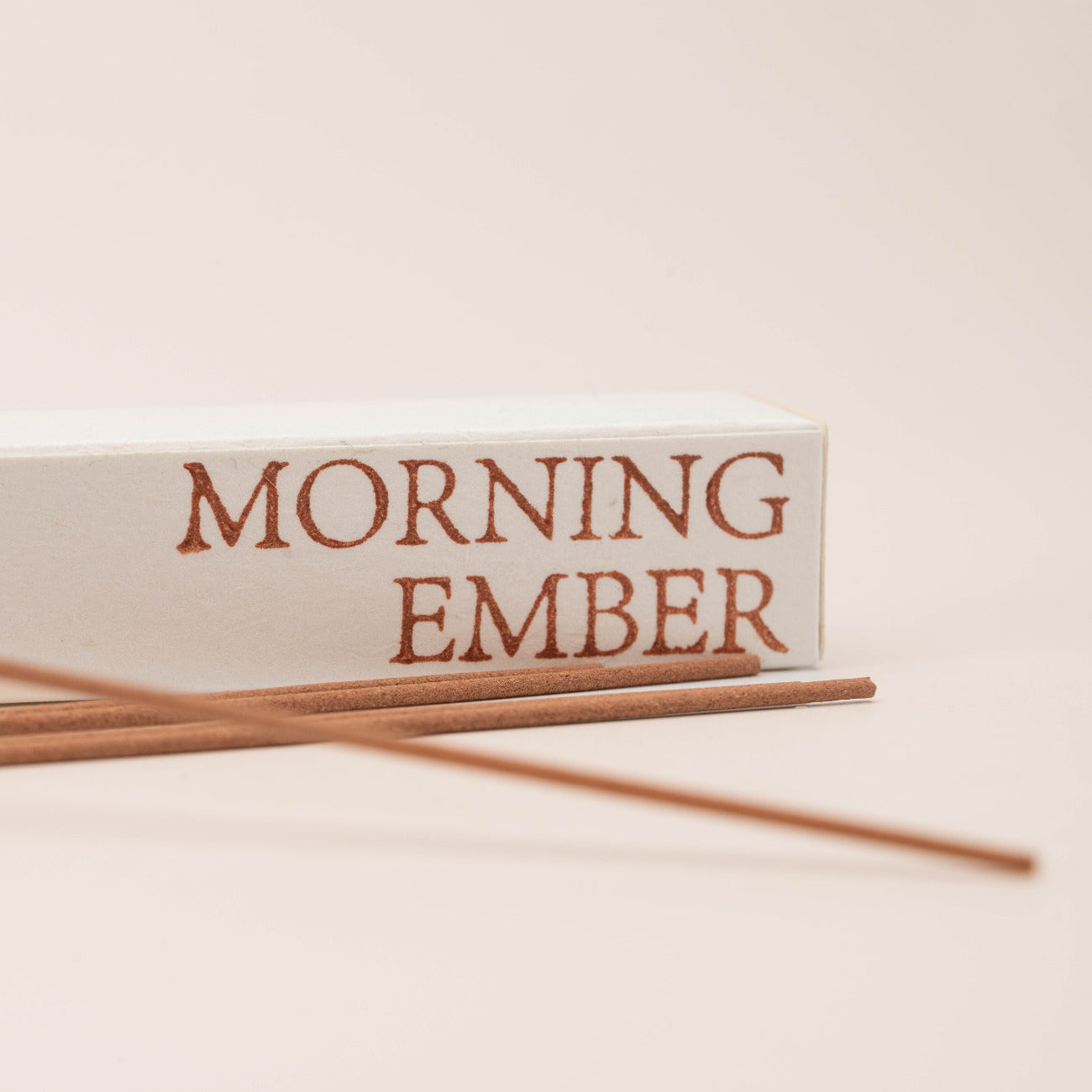 Close-up of SomaScents Morning Ember incense sticks, displayed on minimalist packaging with a soft, neutral background.