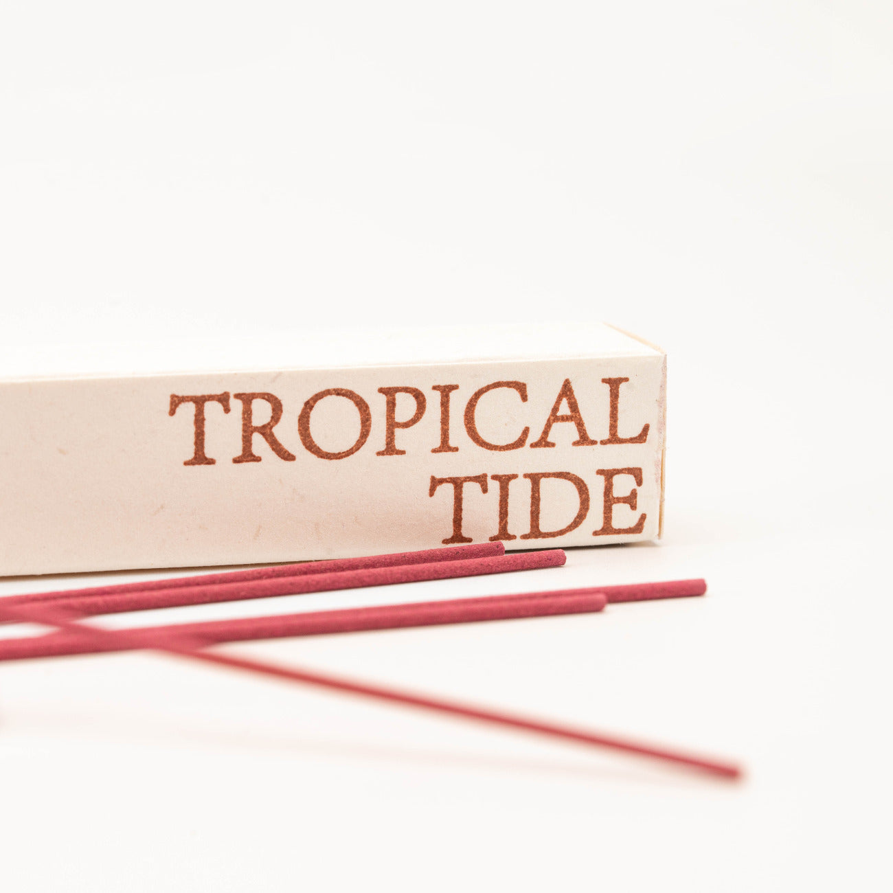 Close-up of SomaScents Tropical Tide incense sticks, displayed on minimalist packaging with a soft, neutral background.