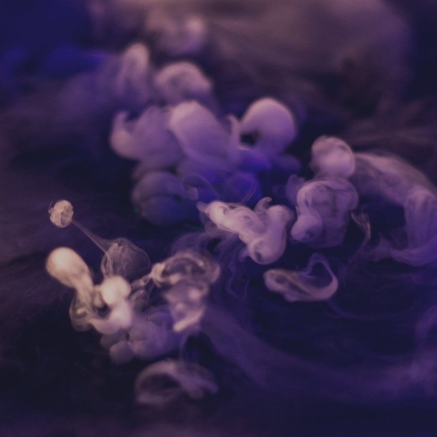 Swirls of violet and white smoke in a dreamy haze