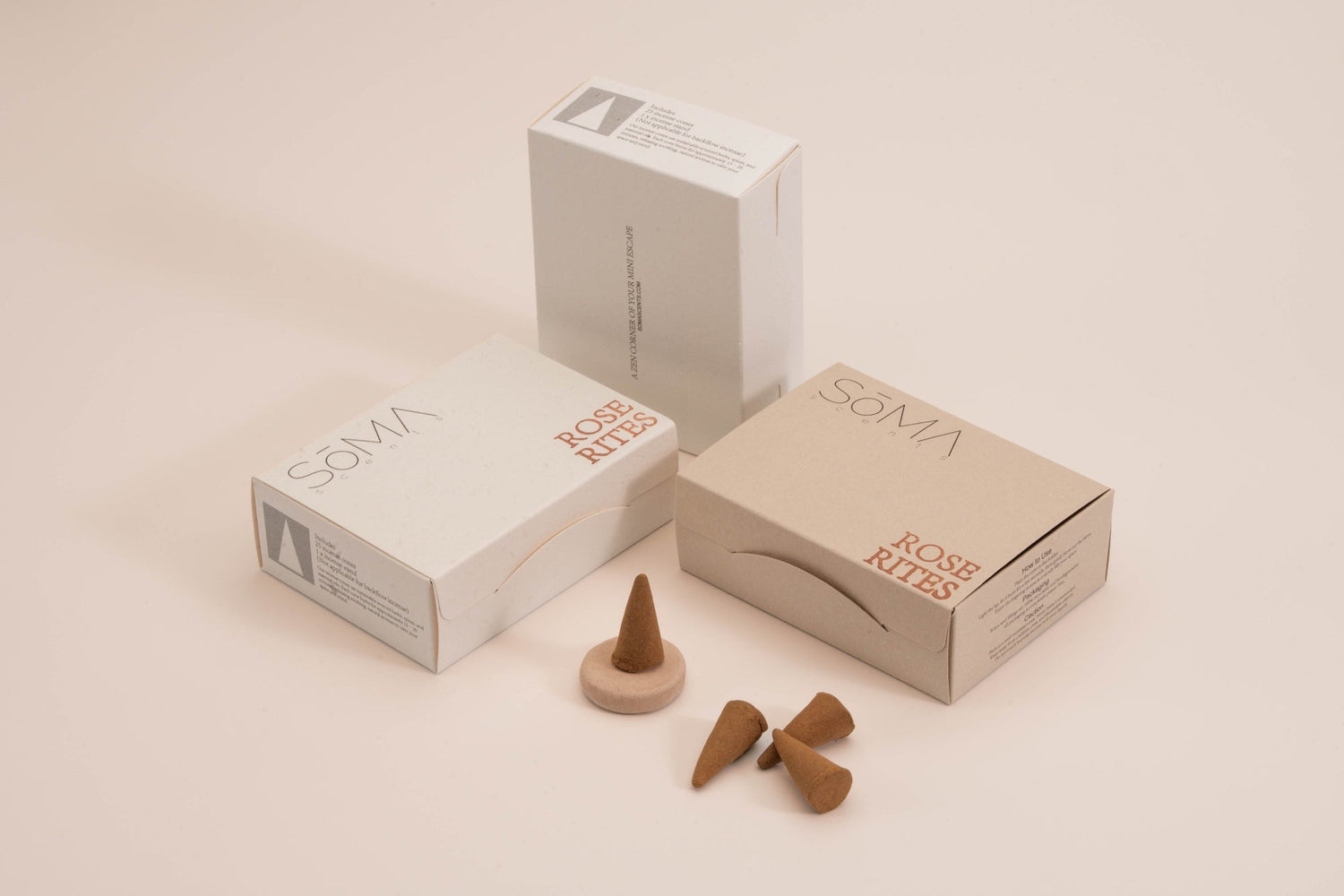 SomaScents incense cones with minimalist packaging and ceramic holder, displayed with natural brown cones on a soft beige background.