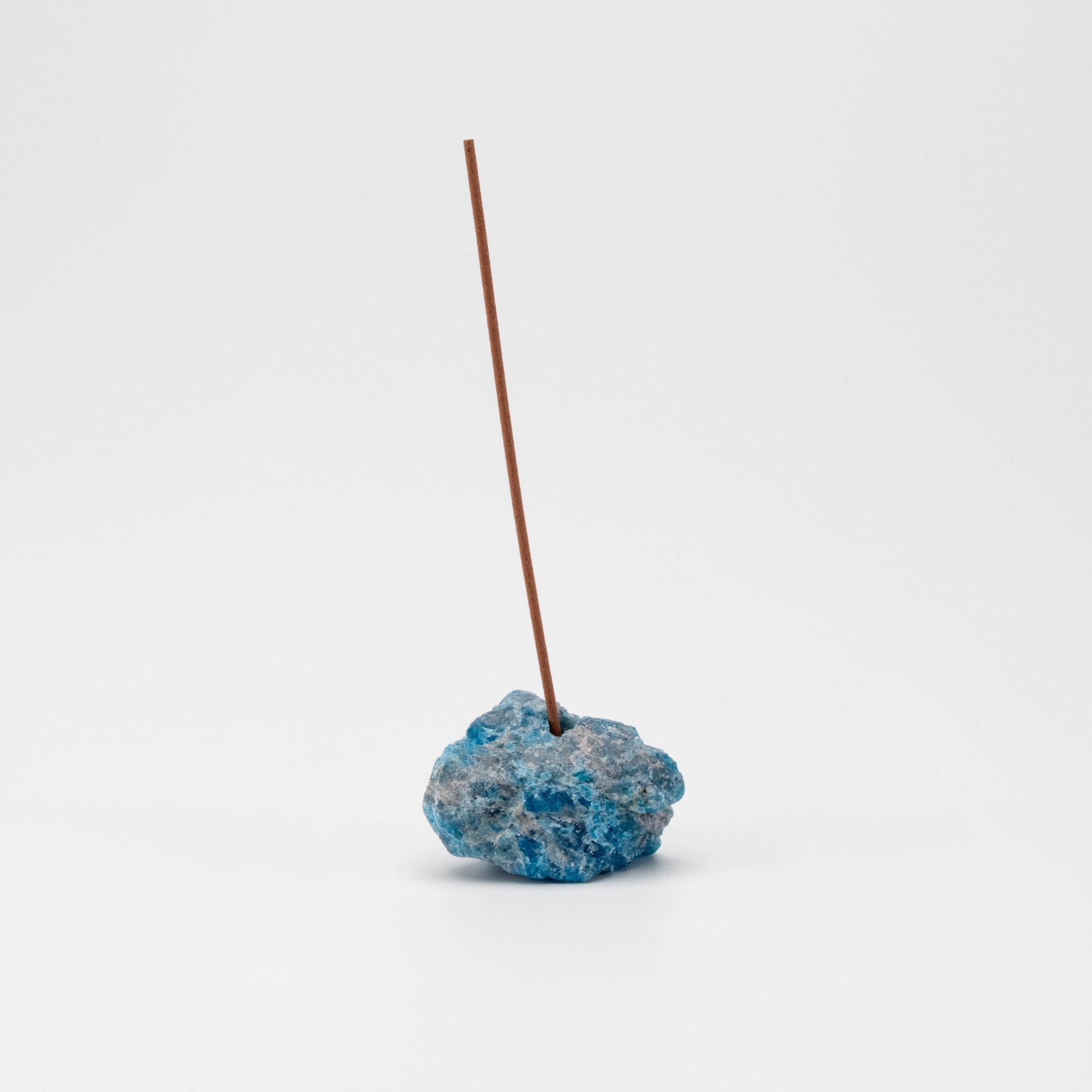 ocean-blue Apatite incense holder with a single upright incense stick