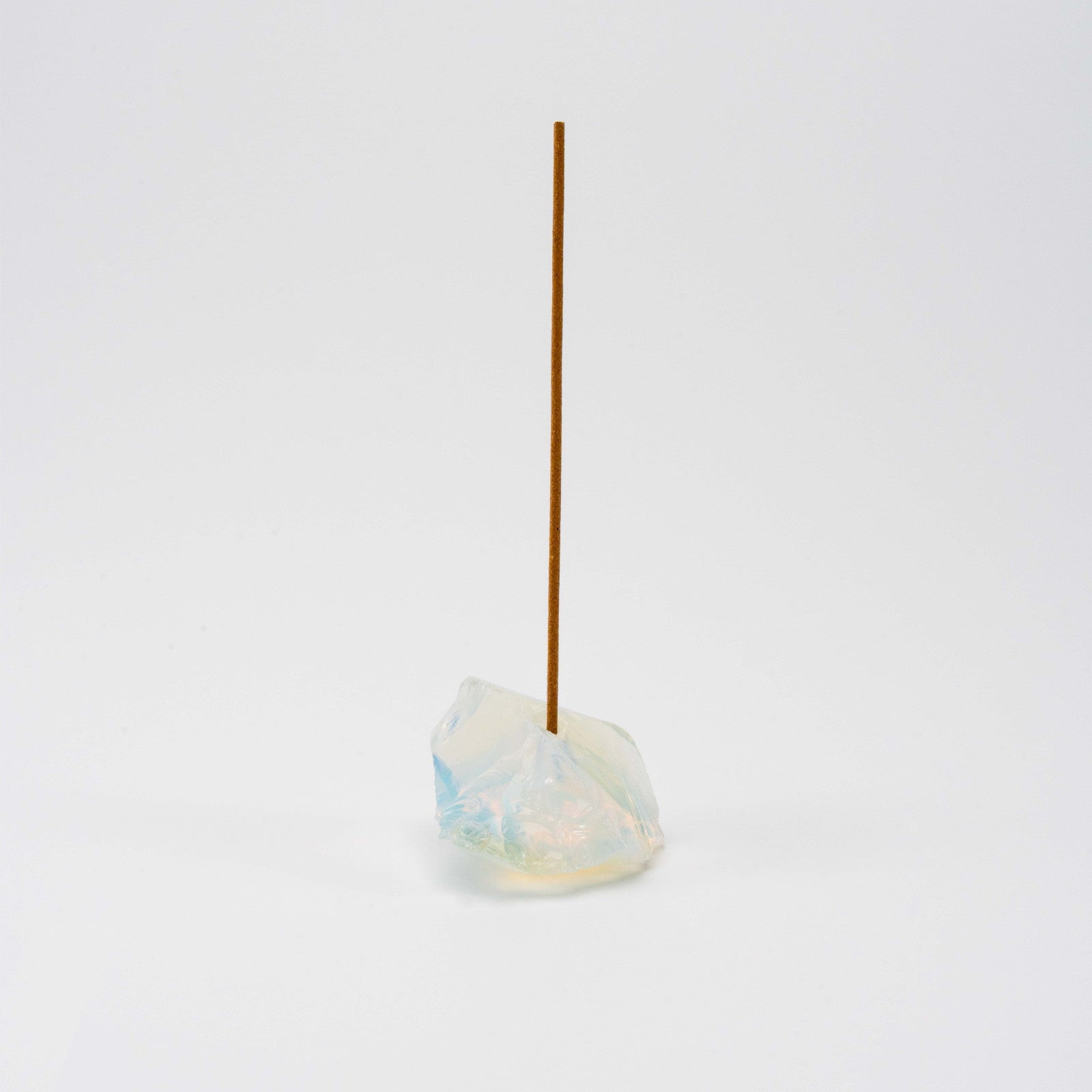 Iridescent Opal incense holder with a single upright incense stick