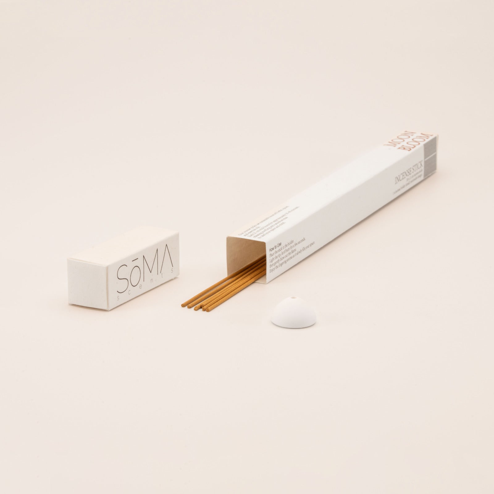 SomaScents Moon Bloom incense sticks in minimalist packaging, displayed with yellow incense sticks and a small white ceramic holder