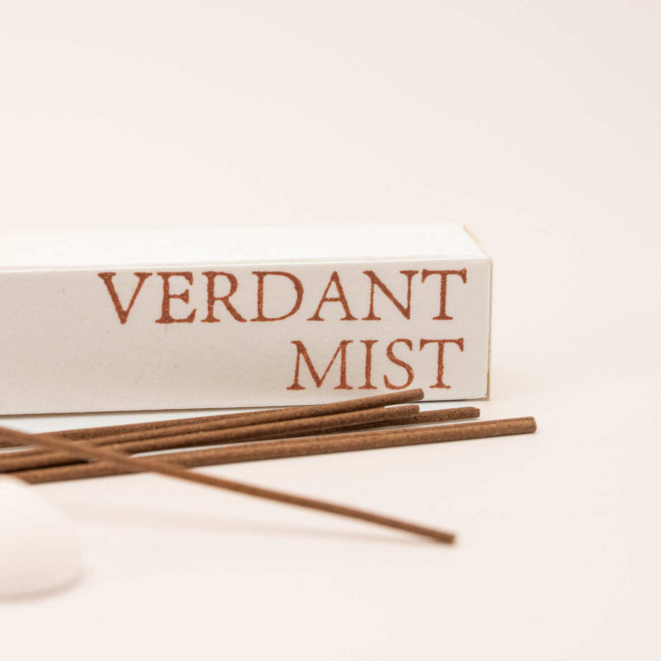 Close-up of SomaScents Verdant Mist incense sticks, displayed on minimalist packaging with a soft, neutral background.