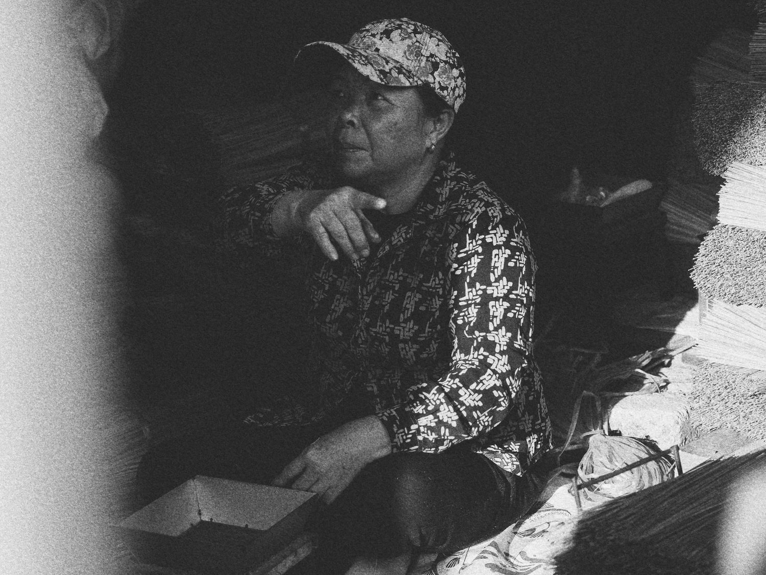 Incense stick maker sorting bundles in a traditional market